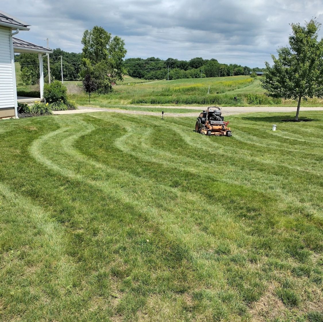 Curved mowing stripes with a SCAG mower on a country lawn