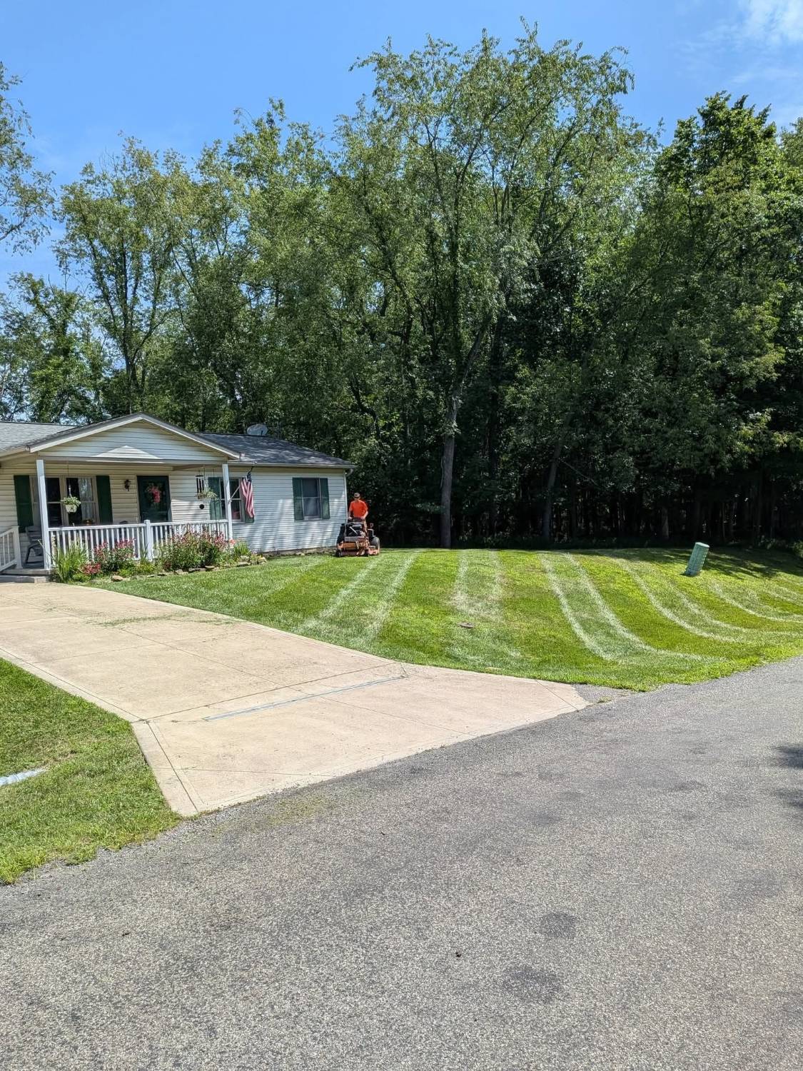 Mowing fresh stripes in front of a house